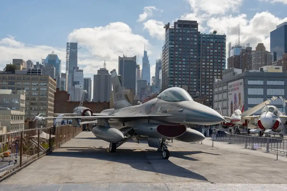 Un caza F-16 expuesto en el Intrepid Museum con el skyline de Manhattan detrás